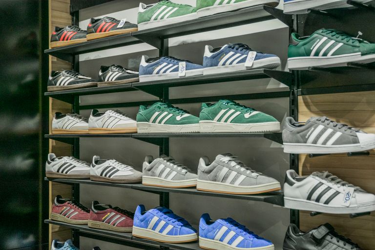 Colorful sneakers arranged on store shelves showcasing trendy footwear options.